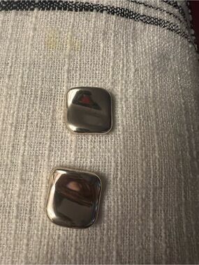 Silver Square Button Accent on Textured White Fabric